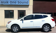 Grey 2013 Nissan Rogue with dark privacy window tint